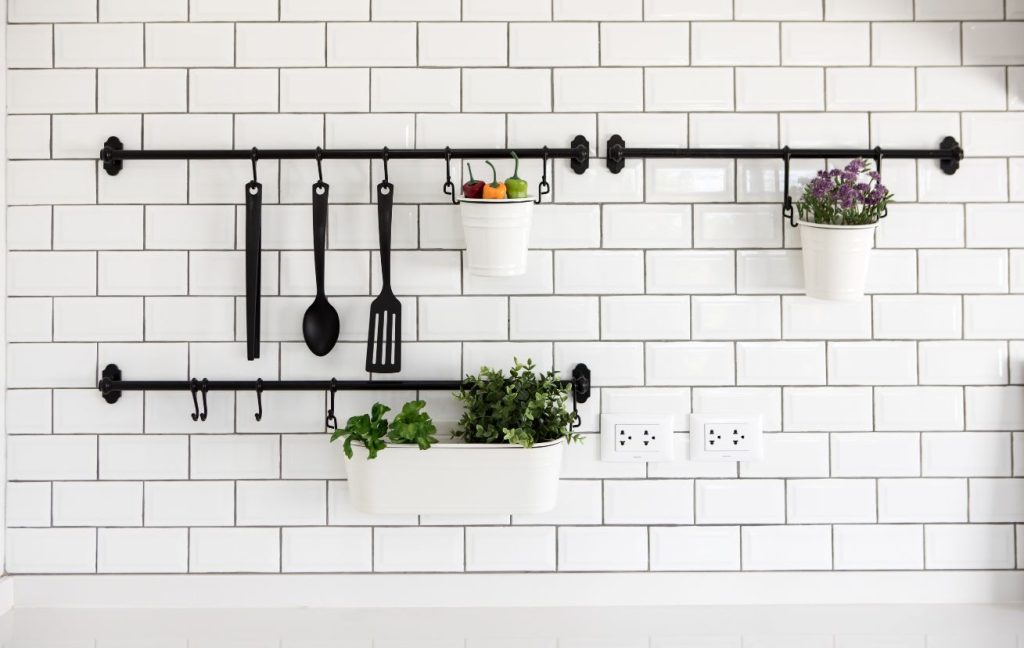 Create additional storage with a tension rod and s-shape hooks